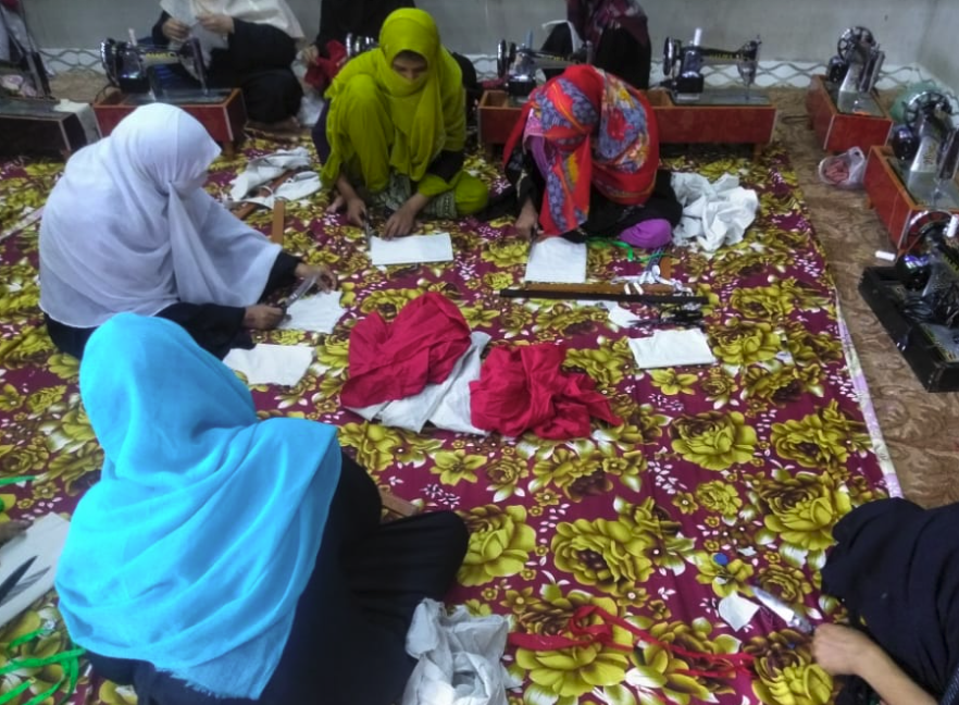 Girls learning to sew and stitch
